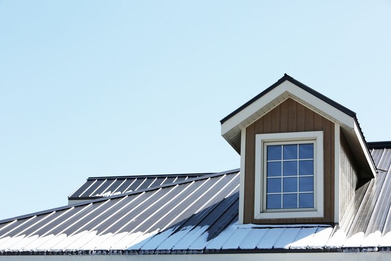 A finished metal roof with a dormer window